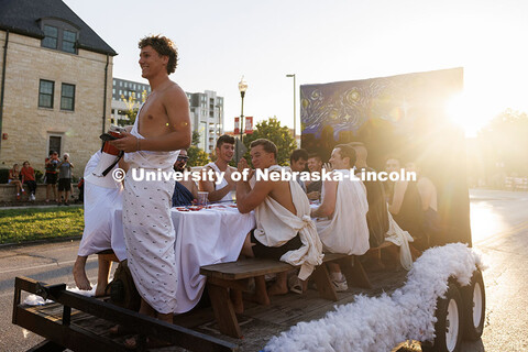 Students dressed up in togas ride on their parade float with the “Stary Night” backdrop. 2025 Ho