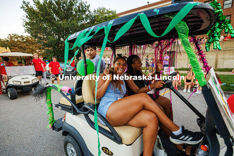 Members of the African People’s Union waves as they drive by in the Homecoming 2025 parade. Homeco