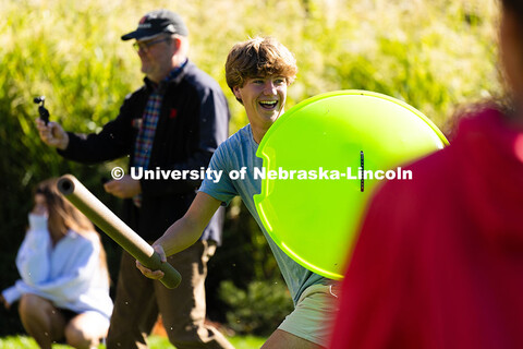 Chase Hake, a first-year student studying business administration, runs through the grass in front o