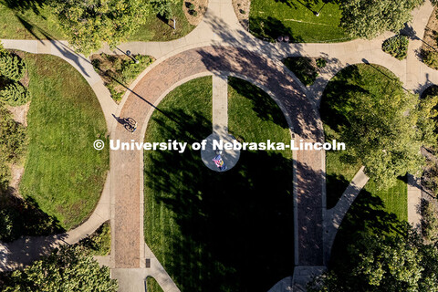 Aerial view of the East Campus Mall as morning sunlight greets a cyclist. October 10, 2025. 