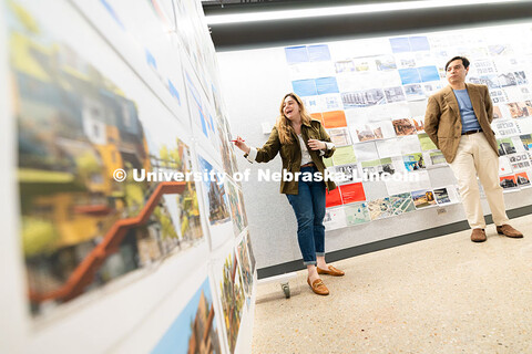 Lívia Loureiro and Davi Xavier, both architecture faculty, discuss student mid-term projects create