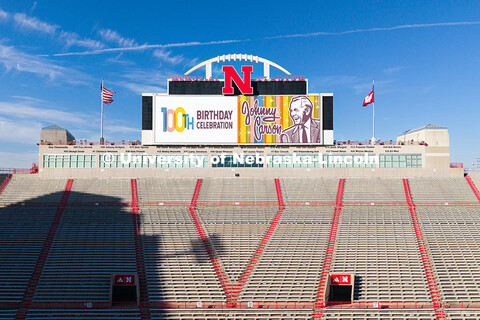 Graphics commemorate Johnny Carson's 100th birthday on the screens in Memorial Stadium. October 16, 