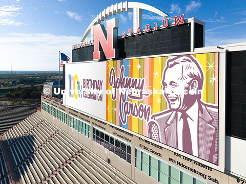 Graphics commemorate Johnny Carson's 100th birthday on the screens in Memorial Stadium. October 16, 