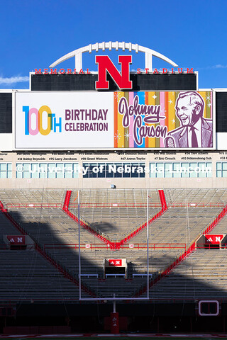 Graphics commemorate Johnny Carson's 100th birthday on the screens in Memorial Stadium. October 16, 