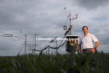 Suat Irmak, Biological Systems Engineering AssociateProfessor, checks his sensing equipment in a soy