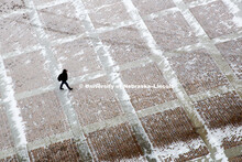 Walking through the snow dusted concourse in front of East Stadium.  Feb. 25, 2014  