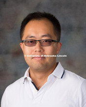 Studio portrait of Yuan Pei, New Faculty Photo Shoot, August 19, 2015. 