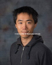 Studio portrait of Qin Zhou, New Faculty Photo Shoot, August 19, 2015. 