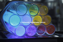 Tubes of various solar-powered catalysts glow in a rainbow of colors under ultraviolet light. Jian Z