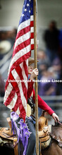 Miss Rodeo University of Nebraska-Lincoln Shelby Riggs brings in the American flag to begin the rode