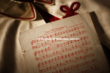 Dear Old Nebraska U sheet music lies on an old drum major cape which now resides in the Alumni Cente