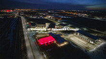 Aerial of Nebraska Innovation Campus lit up red for Glow Big Red. Glow Big Red bathes the campuses w