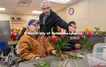 Stacy Adams (center), associate professor of practice in agronomy and horticulture, helps two studen