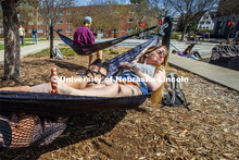 Sammy Cope, freshman from Omaha, enjoys the sunshine as she and Calli Mah, freshman from Mitchell, S