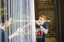 College of Architecture High School Workshop students use string to design in the atrium of the coll