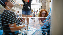 College of Architecture High School Workshop students use string to design in the atrium of the coll