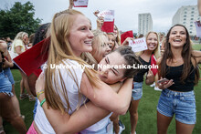 New sorority members celebrate their bids as they open their invitations on the intramural fields. S