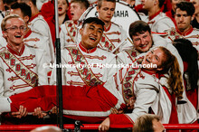 Cornhusker Marching Band Cymbals section holding girl singing hey baby tune at the Nebraska vs. Ohio
