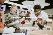 Lily Bruner and Terrol Wilson draw up liquids in a Chem 109 lab to determine absorption spectra and 