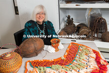 Priscilla Grew, director emerita, admires objects in the University of Nebraska State Museum’s Afr