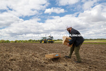 James Schnable positions boxes of seed packets in the field to speed up the planting process. James 