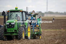 Christine Smith pours a packet of seeds into the hopper as the tractor slowly travels the field. Jam