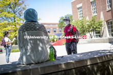 Mark Iradukunda wears a mask while he talks with Sonoor Majid. Photo shoot of students wearing masks