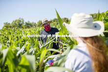 James Schnable talks Christine Smith while supervising students sampling corn plants in each plot us