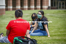 Photo shoot of students on city campus display mask wearing and social distancing. Students hang out