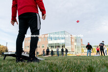 Students toss beanbags during the ASUN Cornhole Competition at the Cather-Pound Greenspace on Wednes