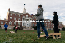 Students toss beanbags during the ASUN Cornhole Competition at the Cather-Pound Greenspace on Wednes