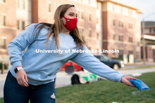 Baylee Gerber throws a beanbag during the ASUN Cornhole Competition at the Cather-Pound Greenspace o