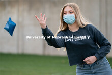 Caroline Ehlert throws a beanbag during the ASUN Cornhole Competition at the Cather-Pound Greenspace