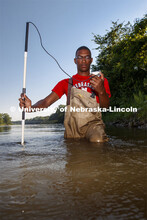 McNair scholar Seth Caines, summer research scholar uses a flowmeter to sample the speed of the Elkh