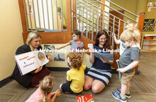 Holly Hatton-Bowers, left, and Carrie Clark read to the children at the UNL Children’s Center. Jul
