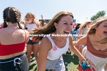 Students run to their chapter during Sorority Rush Bid on the Vine Street fields. Sorority bid day r