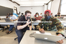 Mehmet Can Vuran works with Joshua Datto, first year graduate student from Rwanda, on his programmin