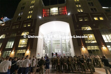 UNL ROTC cadets and Lincoln first responders stand in formation on the east stadium steps to listen 
