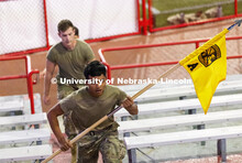 Army ROTC cadet Hsee Htoo carries the unit guidon up the steps. UNL ROTC cadets and Lincoln first re
