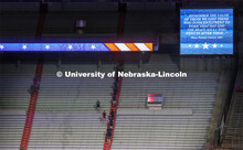 Navy and Marine ROTC members run up the east stadium steps. UNL ROTC cadets and Lincoln first respon