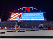 Air Force ROTC members and cadre run the north stadium steps under the video board Thursday morning.