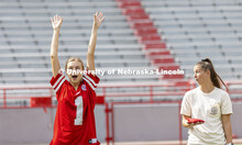 Maggie McCabe, left, a junior with the Kappa Kappa Gamma team, raises her arms after tossing the bag