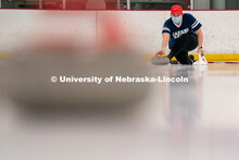 Sam Lydiatt serves during curling practice at the John Breslow Ice Hockey Center. Curling Club. Febr