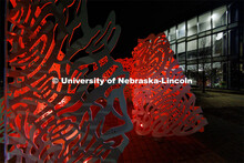 The sculpture Reverie is lit up red outside the  International Quilt Study Center and Museum for Glo