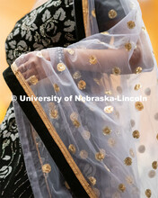 International students walk across the runway wearing cultural garments during the Global Glam fashi
