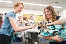 Students pet animals during the End of Year Bash inside the East Campus Union on Saturday, April 30,