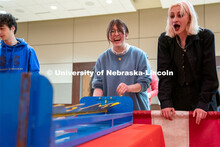Students play carnival games during the End of Year Bash inside the East Campus Union on Saturday, A