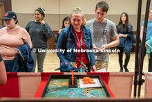 Students play carnival games during the End of Year Bash inside the East Campus Union on Saturday, A