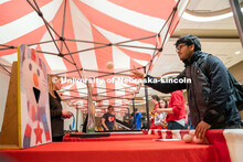 Students play carnival games during the End of Year Bash inside the East Campus Union on Saturday, A