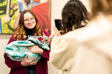 Students pet and hold animals during the End of Year Bash inside the East Campus Union on Saturday, 